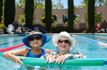 two woman smiling in pool