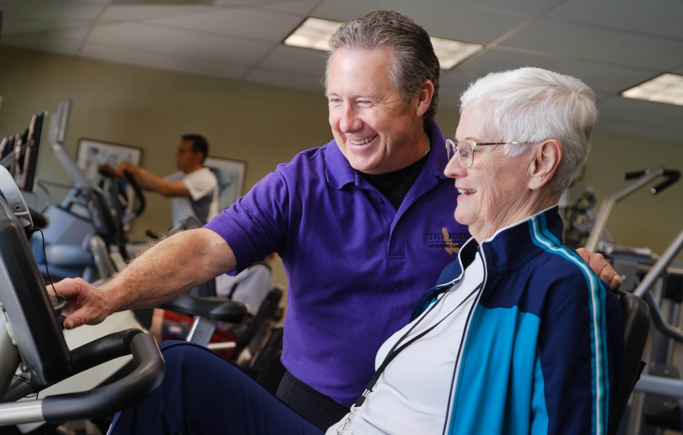 trainer assisting cyclist