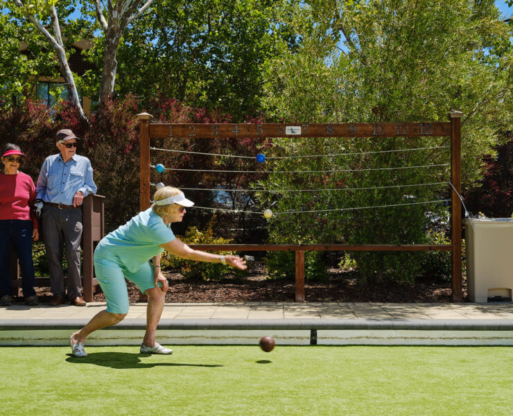 Woman tossing bocce ball