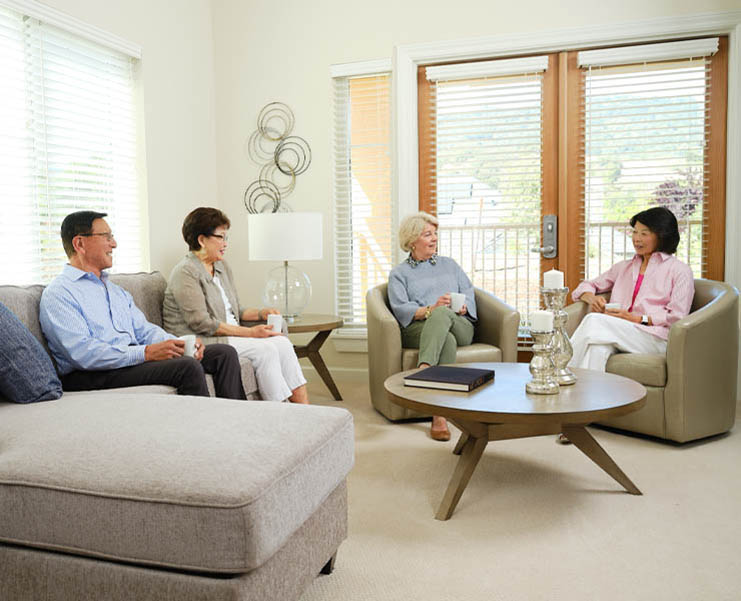 Seniors gather for coffee in their living room