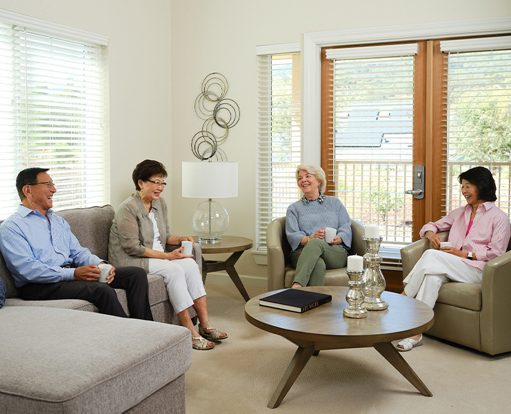 Group of people sitting together and drinking coffee